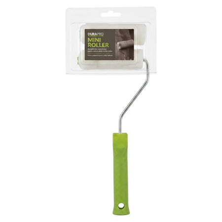 A 110 mm paint roller with a bright green handle, a silver metal frame, and a white sponge roller head, still in its clear