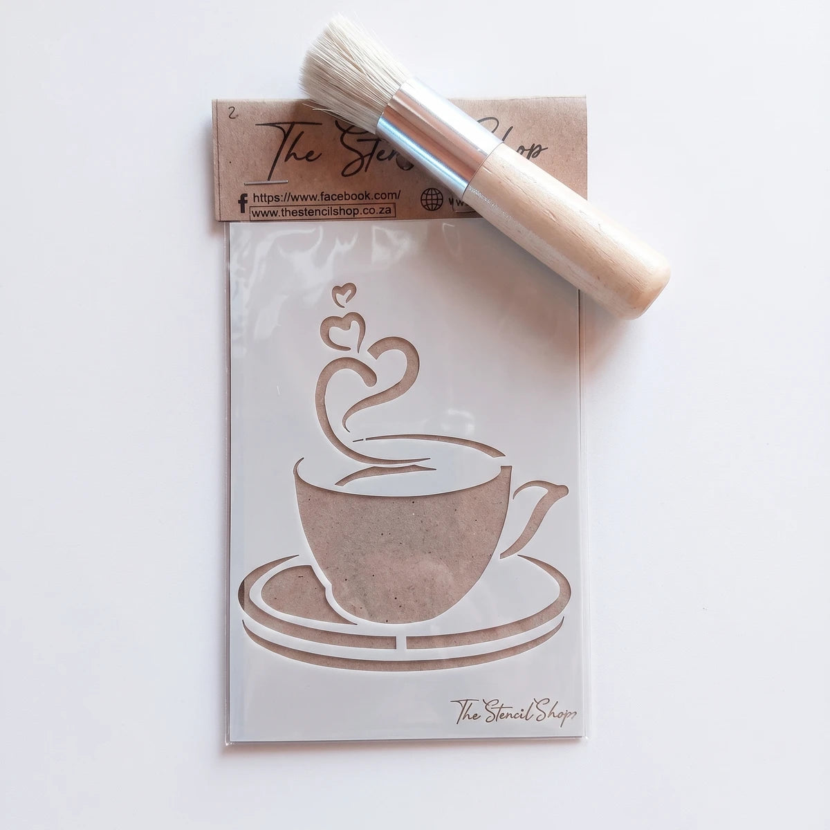 White plastic 2020-A6-2 paint stencil featuring a coffee cup with heart-shaped steam, accompanied by a wooden handle stencil
