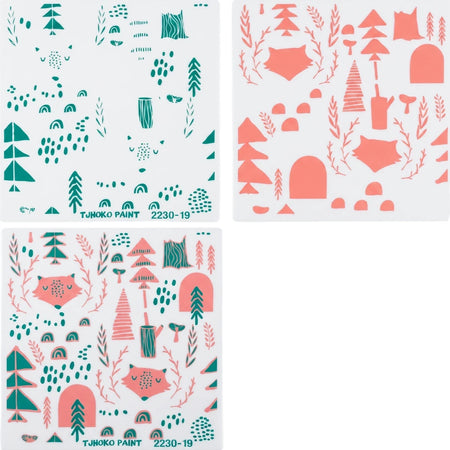 Forest-themed paint stencils, including trees, foxes, mushrooms, and rainbows, in teal green and pink colors.