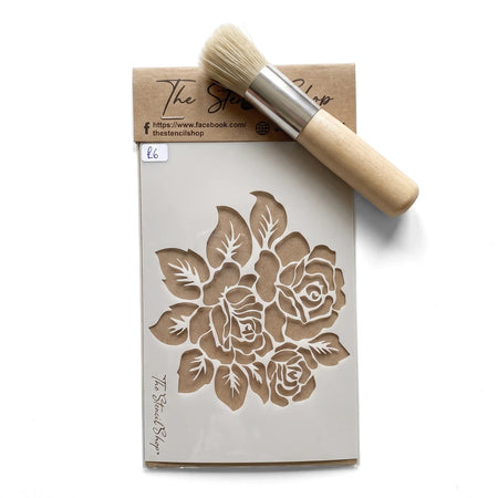 White rose paint stencil with a small application brush and brand tag, shown in a flat lay, suitable for crafting projects.