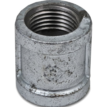 Close-up view of a 3/4 inch galvanized metal pipe socket with internal threading and a textured finish.
