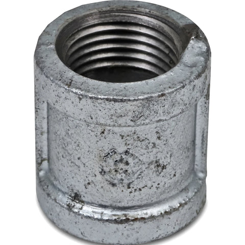 Close-up view of a 3/4 inch galvanized metal pipe socket with internal threading and a textured finish.