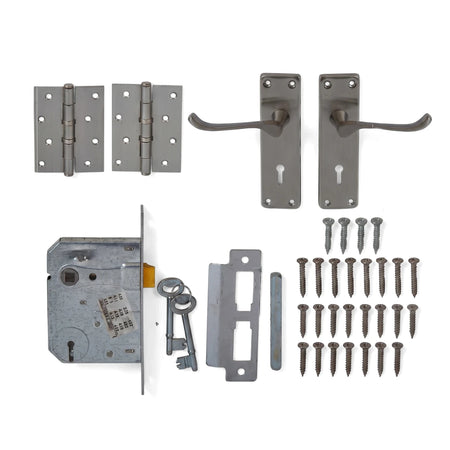 A complete 3 Lever Lockset Victorian Scroll set, featuring two dark grey door handles, two hinges, a mortise lock, two keys,