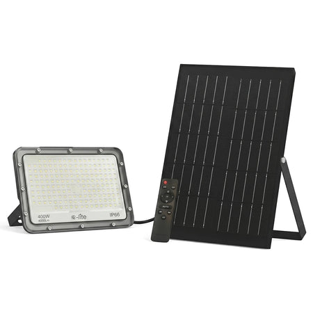 A grey 400W solar flood light with a separate black solar panel and remote control, providing cool white illumination.