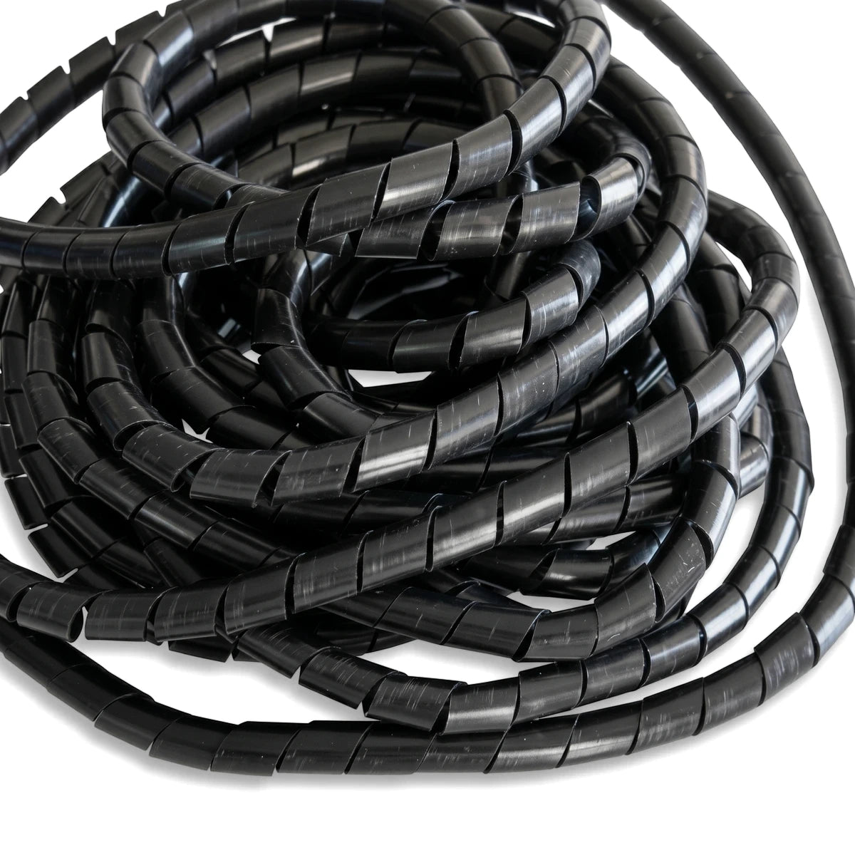 Black 7.5mm spiral wrapping cable organizer coiled in a stack, showcasing its flexible design.