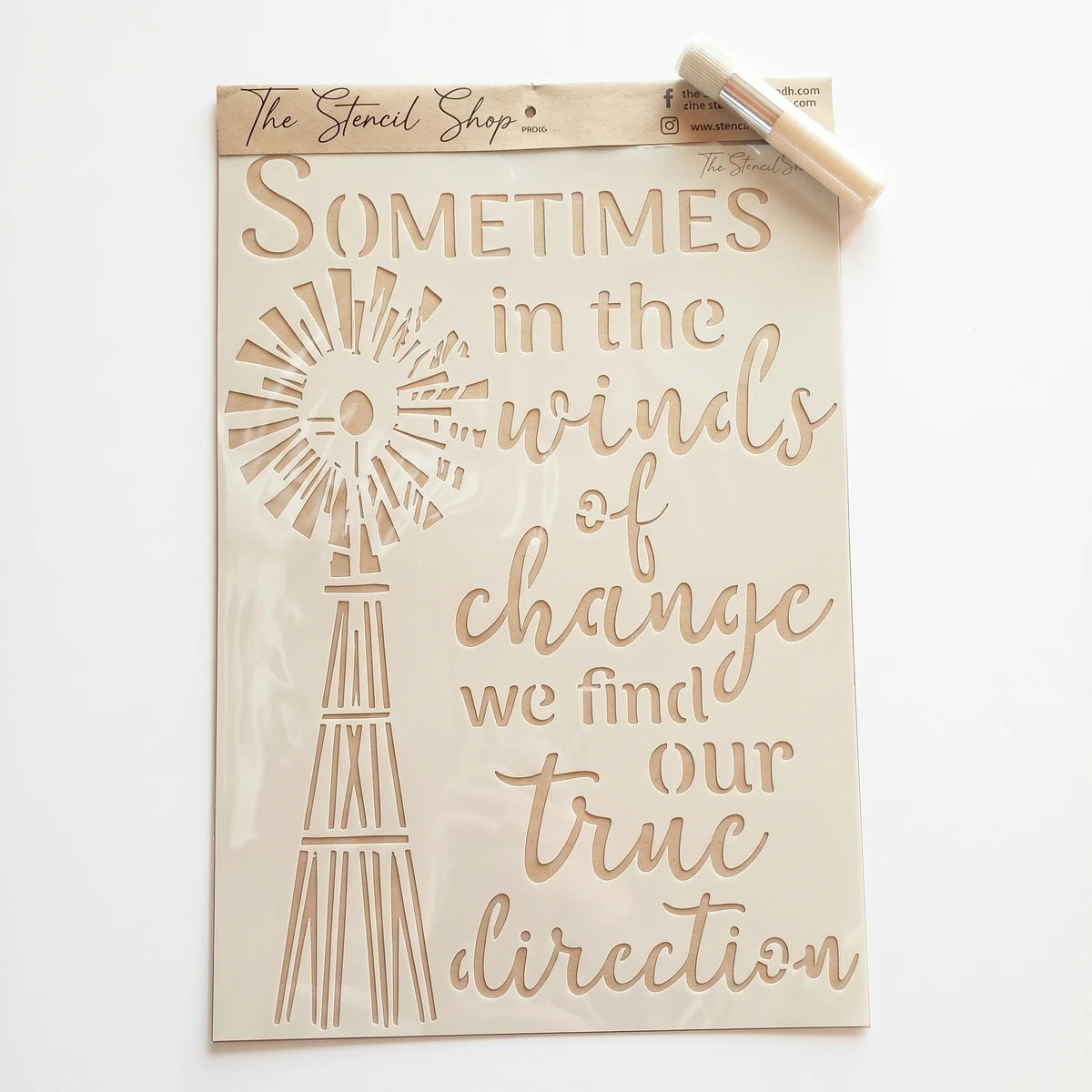 A3-27 Stencil 87 paint stencil with a windmill design and inspirational quote on a patterned rug.