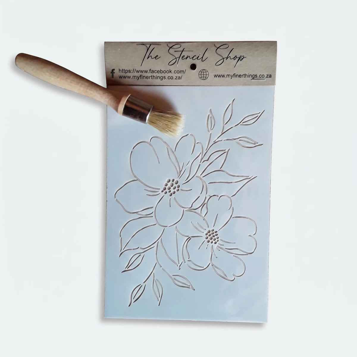 White A5-22 Stencil 43 paint stencil with a delicate floral design and a wooden stencil brush, ideal for art projects.