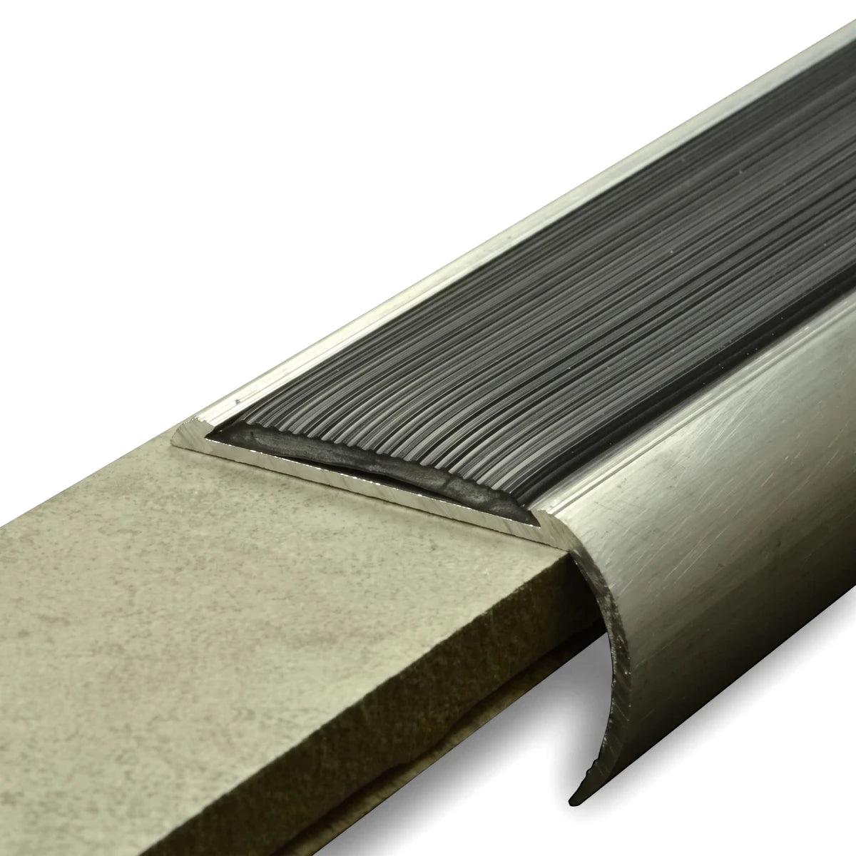 Close-up view of an Aluminium Retrofit Bullnose Stair Nosing with a black ridged PVC infill, installed on a concrete step.