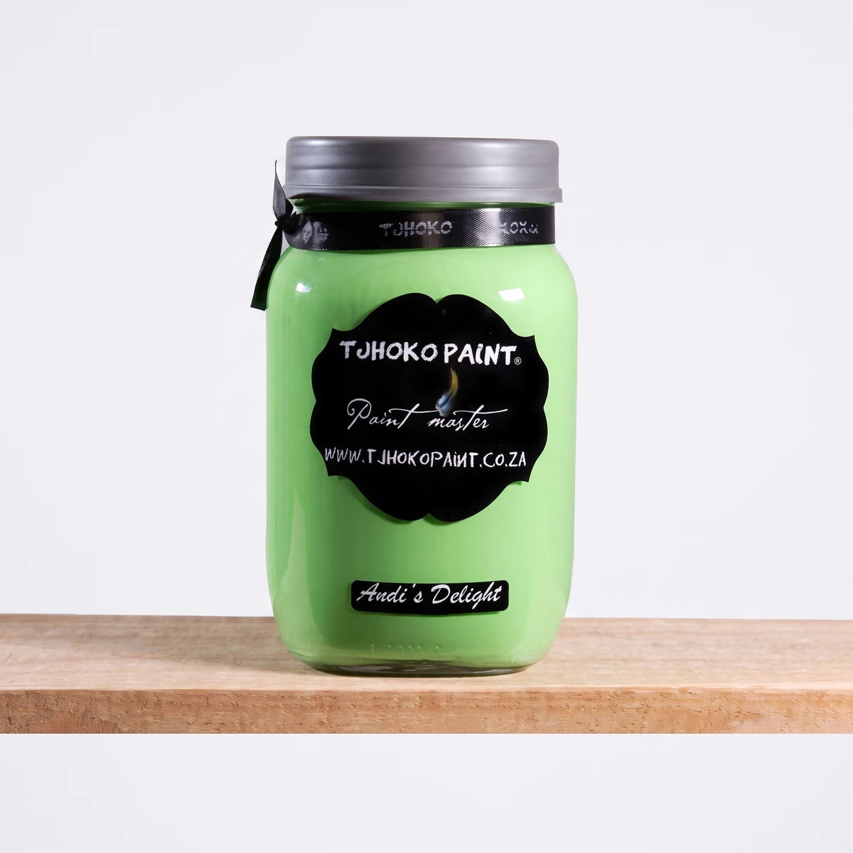 Andi's Delight 1L Chalk Paint in a light green glass jar with a black label, presented on a wooden surface.