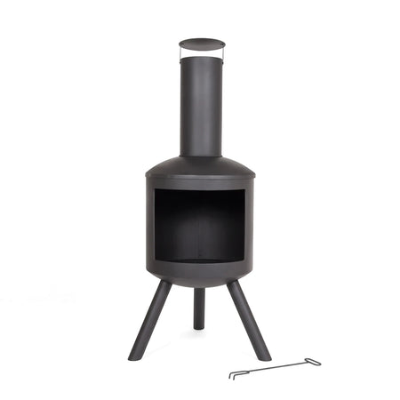 Modern black metal outdoor chimenea with a tall chimney and a small poker tool on a white background, front view.