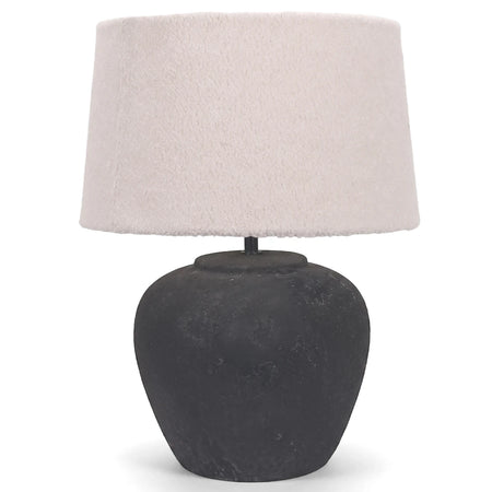 Black ceramic base table lamp with a textured cream fabric shade, perfect for ambient lighting.