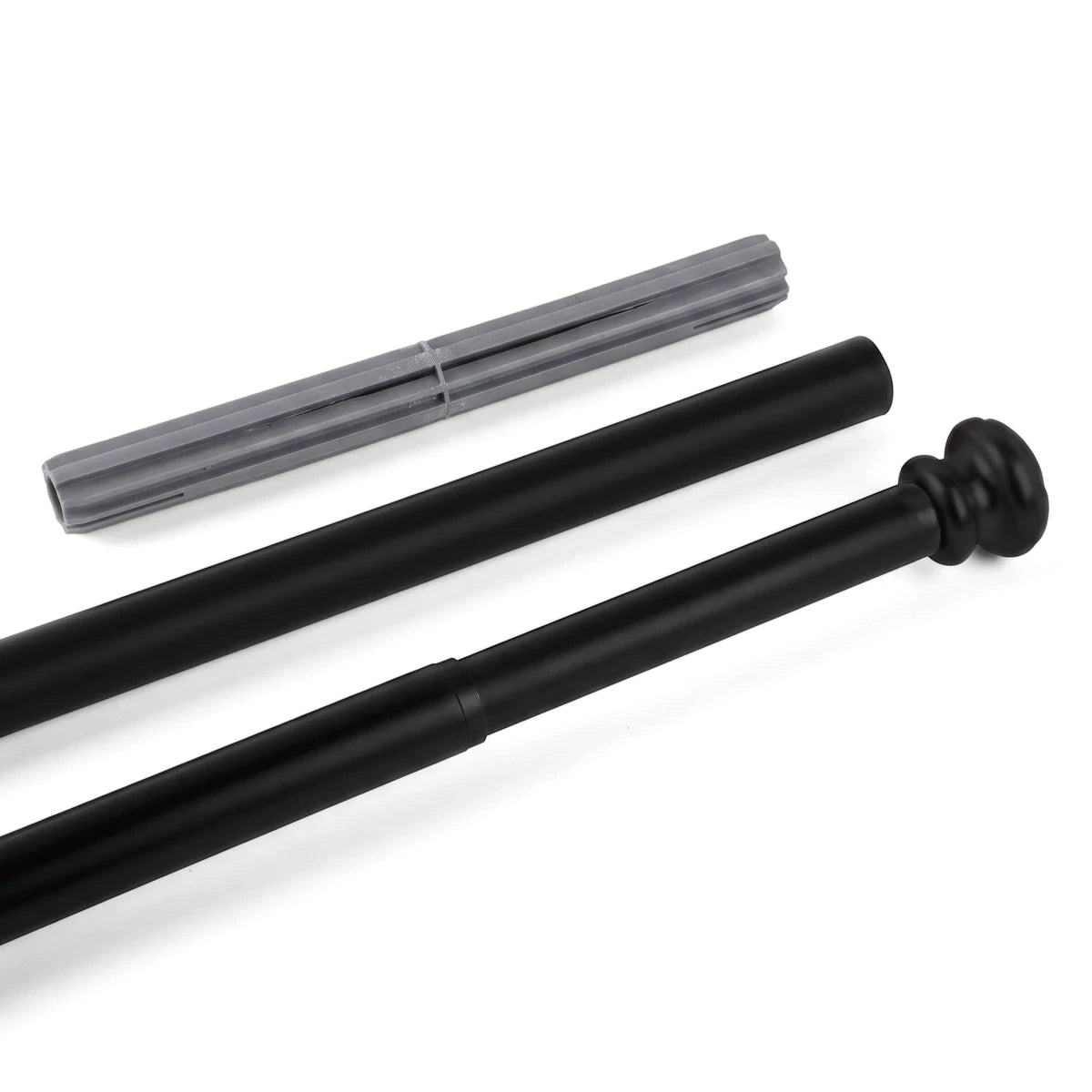 A black large shower curtain rod with a decorative finial and a grey ribbed extender piece, angled on a white surface.