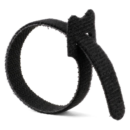 Black Magic reusable cable tie, looped and secured, showing its soft fabric hook-and-loop fastening.