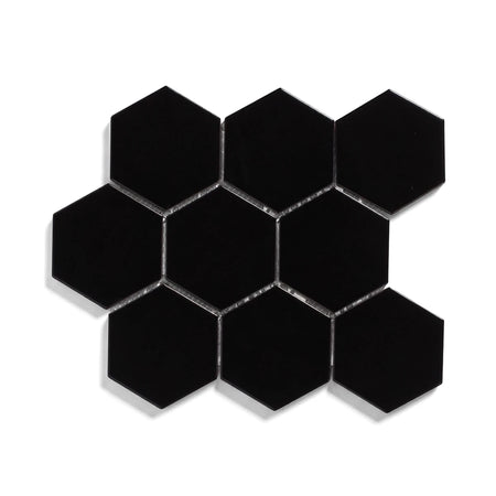 Black matte large hexagon mosaic tiles arranged in a geometric cluster with light gray grout, isolated on a clean white