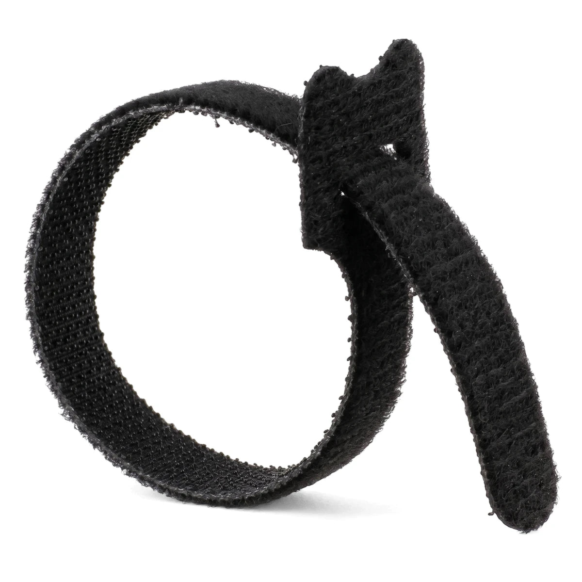 A single black reusable hook-and-loop cable tie curled in a loop on a white background, for cable management.