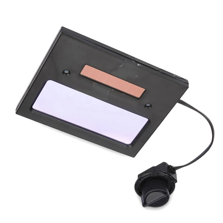 Black solar auto-darkening welding helmet lens with a connected control knob, angled, highlighting its features for eye