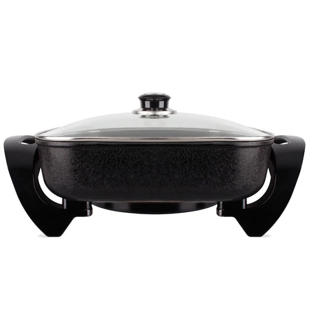 Black textured aluminum electric frying pan with a clear glass lid and black handles, shown from a front view.