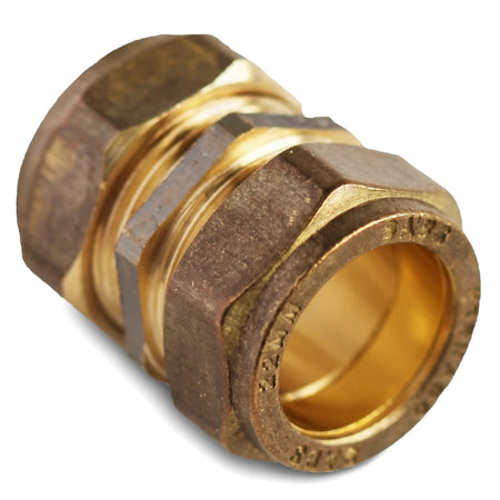 Brass 22mm straight CXC compression coupler plumbing fitting, viewed at an angle on a white background, showcasing its