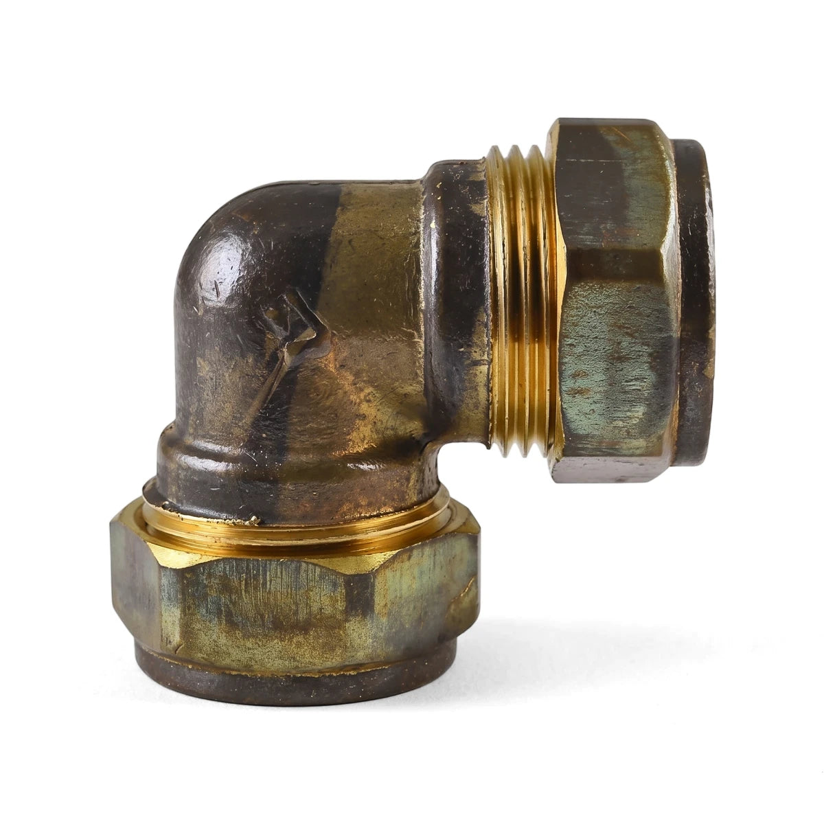 Brass 90-degree pipe elbow with compression fittings for plumbing applications, isolated on a white background.