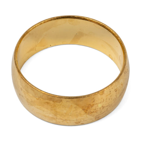 A gold-colored brass compression ring, circular in shape with a slightly worn texture, presented on a white background.
