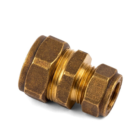 Brass straight CXC compression coupler plumbing fitting with hexagonal nuts, viewed at an angle on a white background.