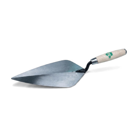 A silver brick trowel with a light wooden handle featuring a green logo, angled against a plain white background.