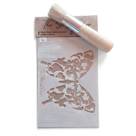 Butterfly paint stencil with intricate leaf design and a wooden-handled stencil brush for creative crafting projects.