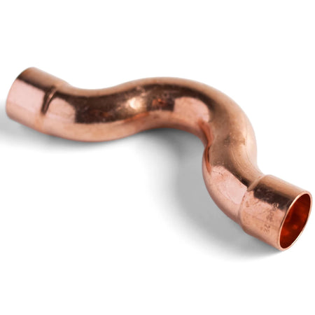 Wavy capillary copper CXC crossover pipe fitting, a curved component for plumbing systems, isolated on a white background.