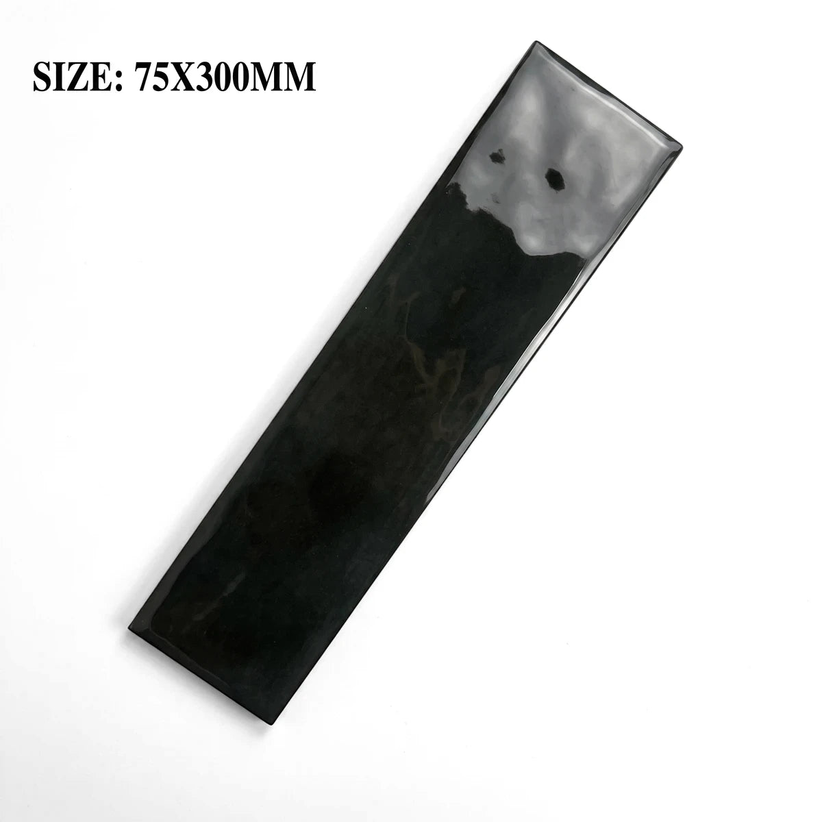 A single dark carbon black glossy ceramic subway tile, measuring 75x300mm, displayed diagonally on a surface.