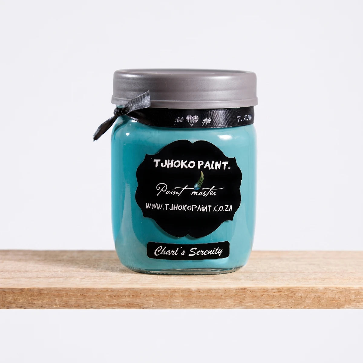 Charles Serenity Colour 4 500ml teal paint jar with a gray lid and black ribbon, displayed on a wooden shelf.