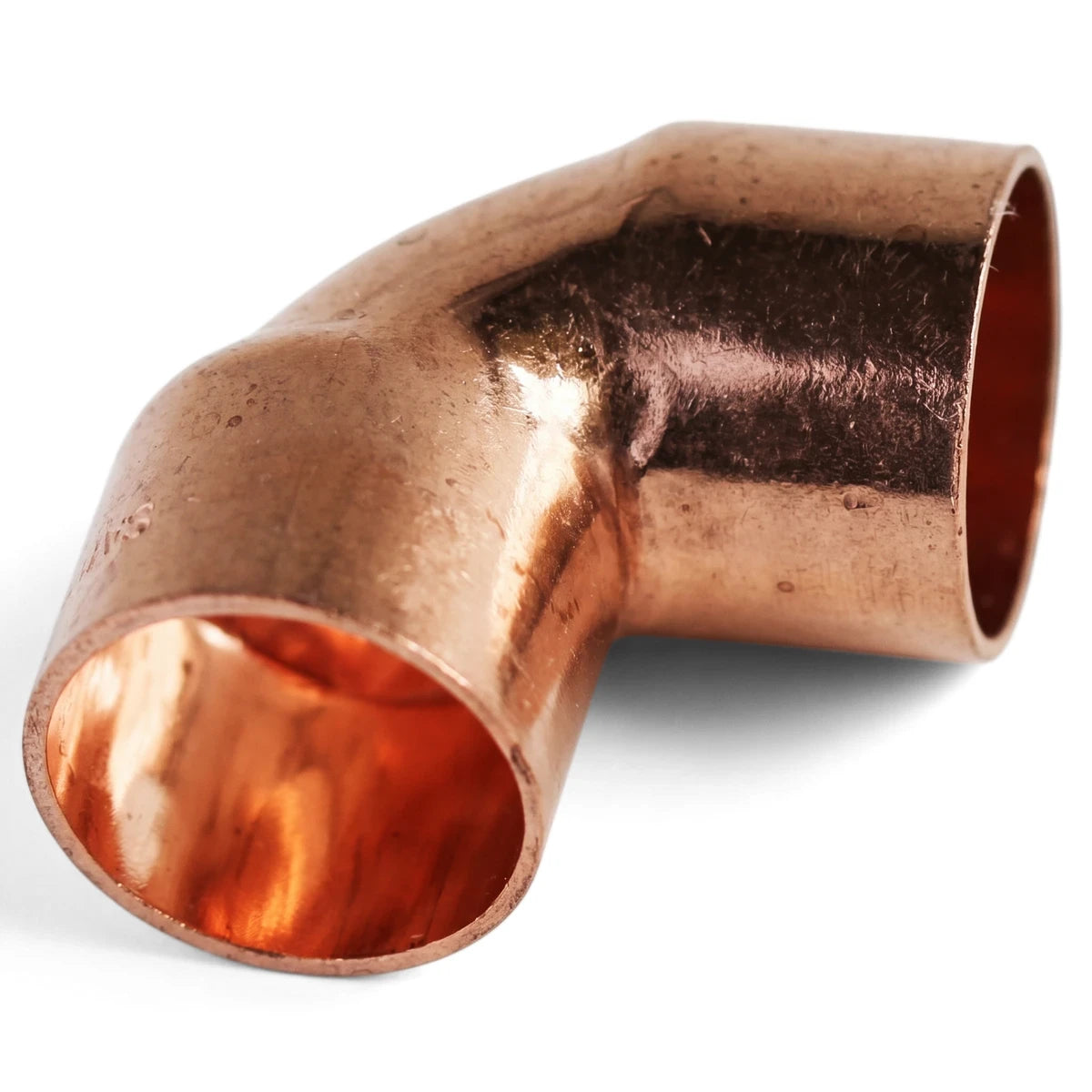 Close-up of a shiny copper 90 Degrees CXC 15mm elbow plumbing fitting for connecting pipes.
