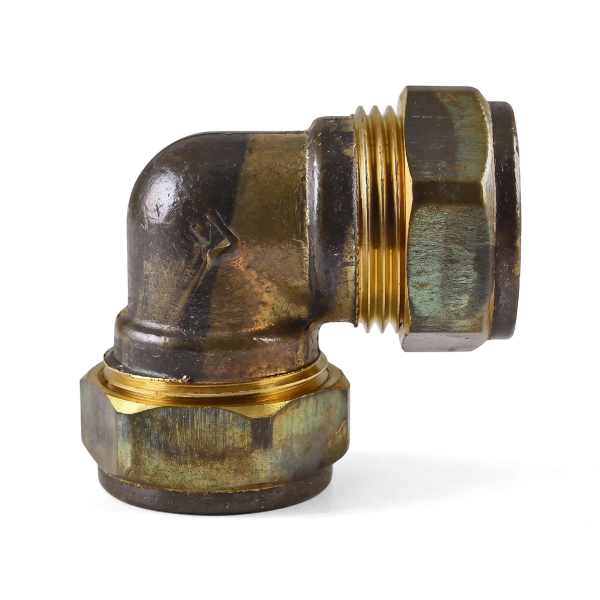 CXC elbow, a weathered brass 90-degree compression pipe fitting with visible threading and hexagonal nuts.