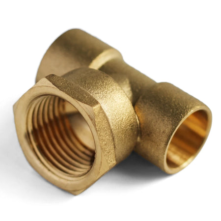A golden brass CXCXFI tee cap plumbing fitting with internal threading and a hexagonal body, viewed from an angled