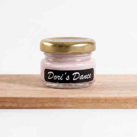 Small Dori's Dance 500ml pink chalk paint jar with a gold lid and black label, resting on wood.