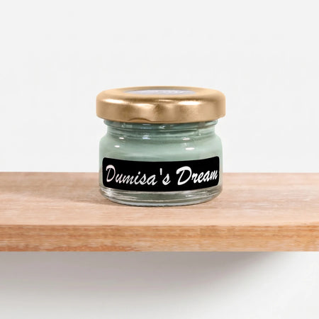 Small glass jar of Dumisa's Dream 25ml Chalk Paint with a golden lid and a black label with white cursive text, on a wooden