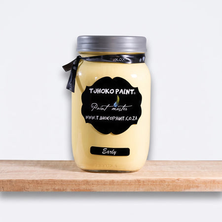 Early 1L Tjohoko Chalk Paint in a clear glass mason jar with a silver lid and black labels, resting on a wooden shelf.