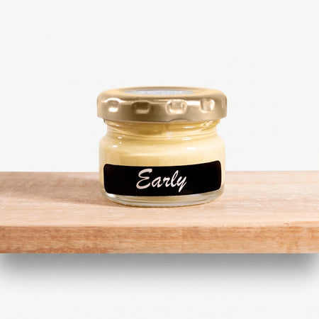 Early 25ml Chalk Paint in a clear glass jar with a gold lid and black label, resting on a wooden surface.