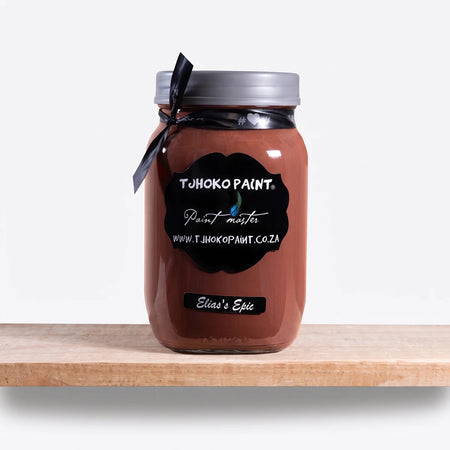 Elias' Epic 1Litre Tjhoko brown chalk paint in a clear glass jar with a gray lid and black ribbon, displayed on a wooden