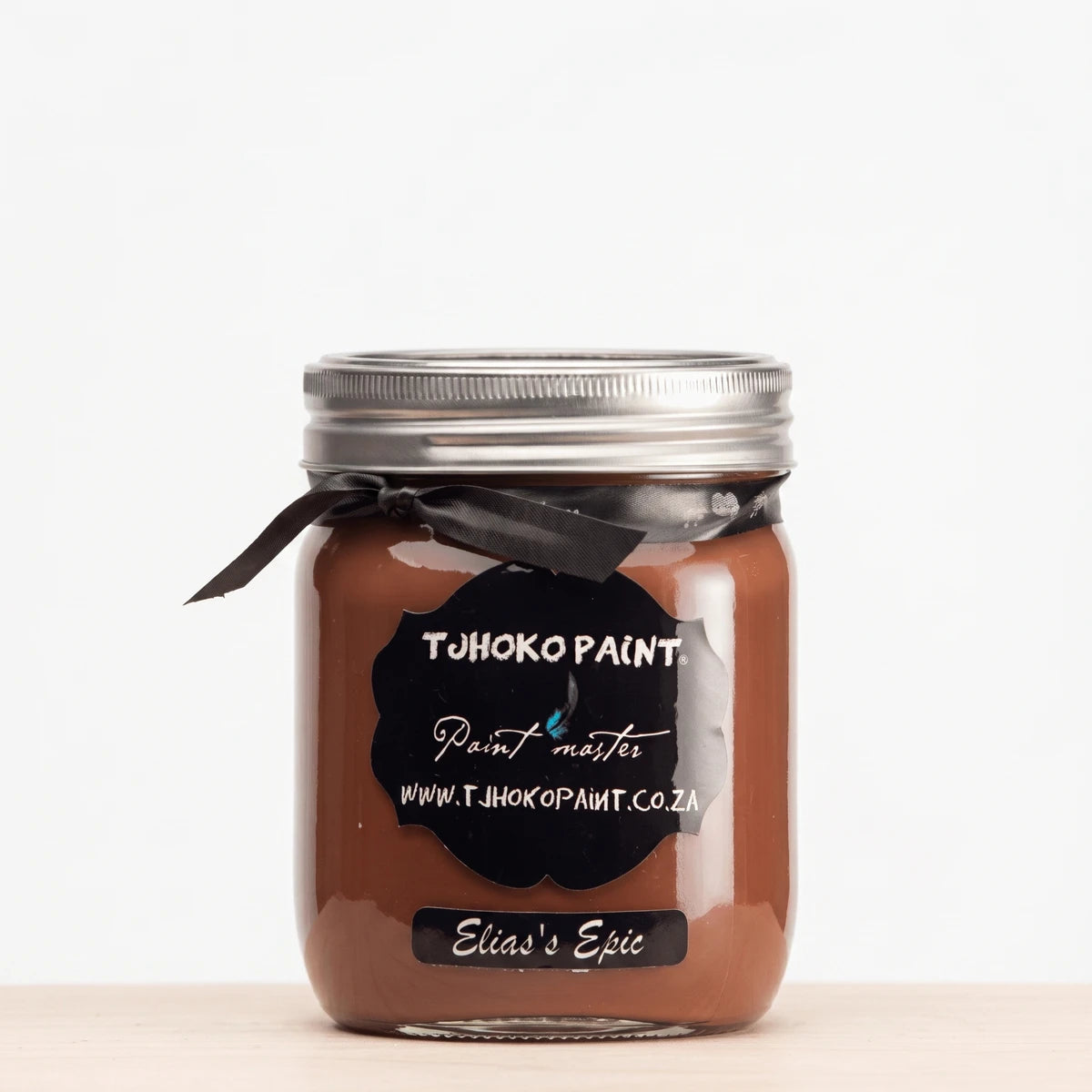 Elias' Epic 500ml Tjohoko chalk paint in a clear glass jar with a metallic lid and black ribbon.