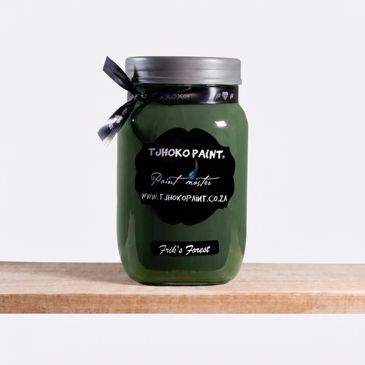 Frik's Forest 250ml Chalk Paint in a dark green glass jar, standing on a wooden shelf.