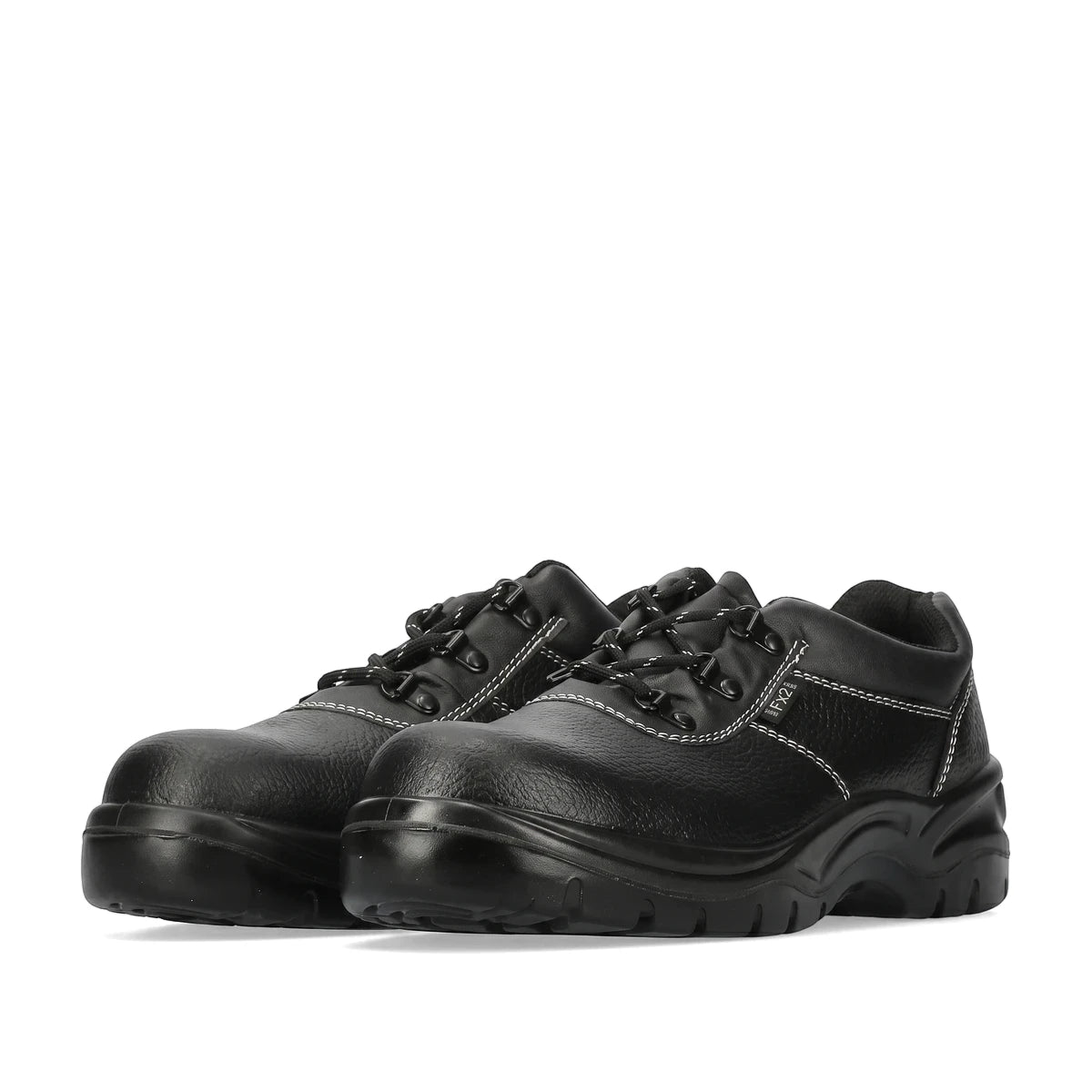 Pair of black Fx2 safety shoes with white stitching and durable black soles, viewed from a low angle.