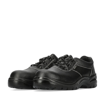 Pair of black Fx2 safety shoes with white stitching and durable black soles, viewed from a low angle.