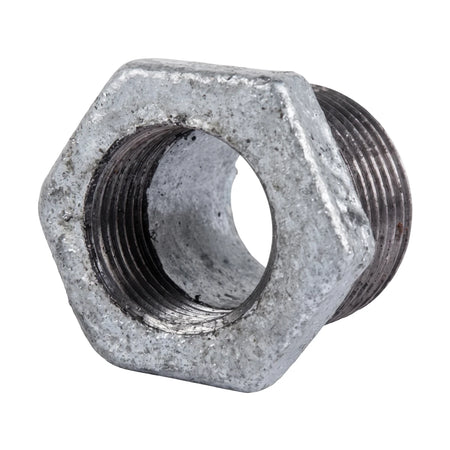 A hexagonal galvanized reducing bush with visible threading on both ends, shown from a slight angle, metallic gray in color,