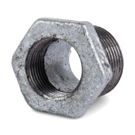 Close-up view of a galvanized reducing bush, male 2 inch by female 1 inch, used for plumbing connections, featuring external