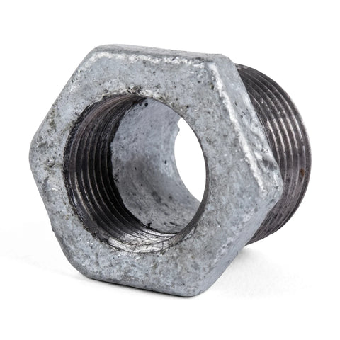 Galvanized reducing bush, a grey metal pipe fitting with male and female threads, shown close up.
