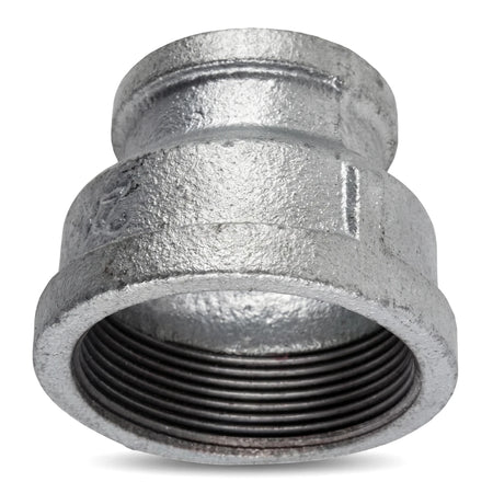 Galvanized reducing socket with 1 1/2 by 3/4 inch threaded ends, shown in an angled close-up view.