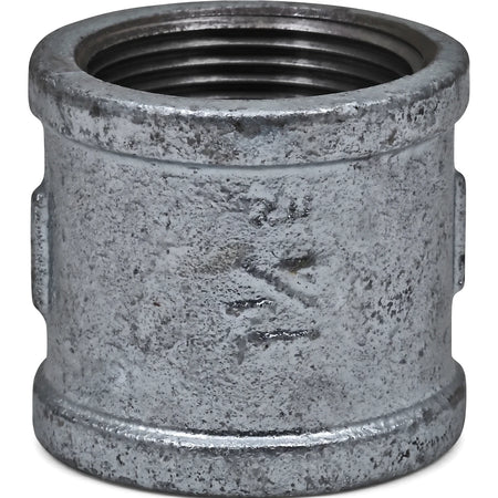 Close-up of a 1 1/4 inch galvanized metal pipe socket with internal threading, viewed from an angled perspective.
