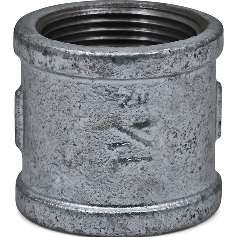 Close-up of a 1 1/4 inch galvanized metal pipe socket with internal threading, viewed from an angled perspective.