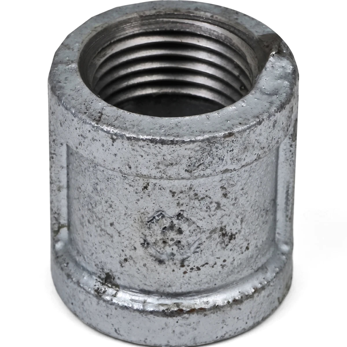 Close-up of a 1/2 inch galvanized steel pipe socket showing internal threading, useful for plumbing connections.