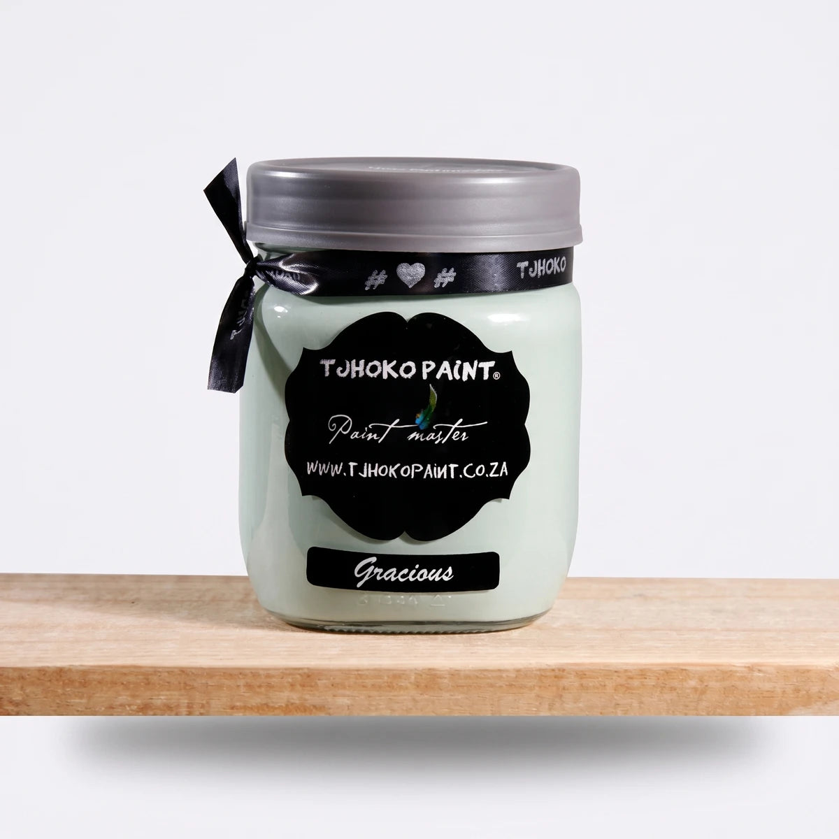 Gracious 500ml Tjohoko Chalk Paint jar in a light mint green color, displayed on a natural wooden shelf.